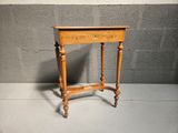 an old wooden table with a drawer on top of it