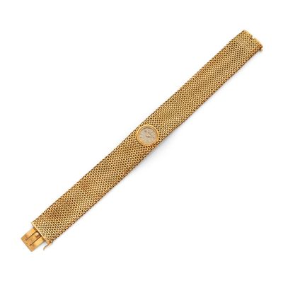 a gold watch with a mesh band on a white background