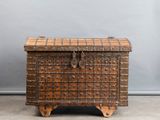 an old wooden chest with a checkered pattern on the top