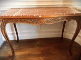 a table with a marble top in a room