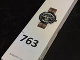 someone is holding a watch in a box on a table