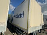 two trailers that are parked in a parking lot