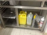 a kitchen with a stainless steel oven and some containers of food