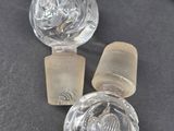 three glass knobs sitting on a black surface