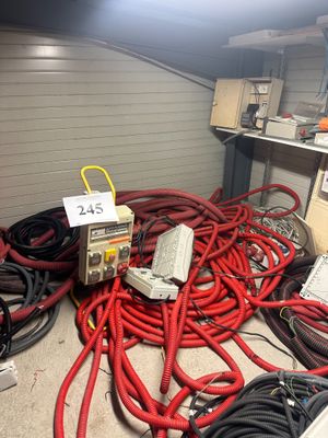 a lot of wires and electrical equipment in a room