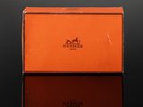 an orange box with a horse logo on it sitting on a table