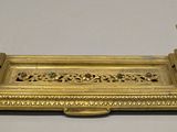 an image of a gold plate with two candles on top of it