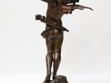 an image of a bronze statue of a boy holding a knife