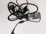 a black power cord and a charger on a white surface