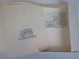an open book with a drawing of a castle on it