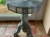 a small table with a fan on it in front of a window