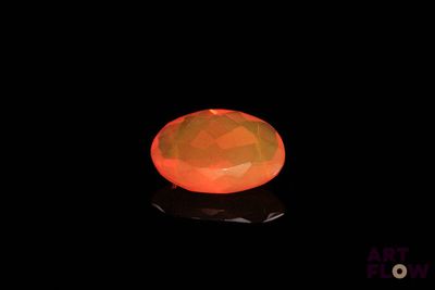 a close up of an orange fire oplite on a black surface