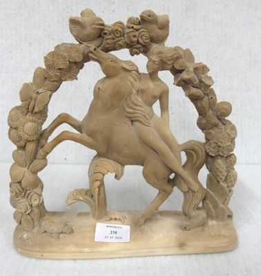 a statue of a woman riding a horse with a bird on its back