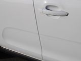 a close up of a car door handle with a sticker on it