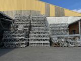 a lot of cages stacked up in front of a building
