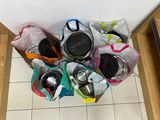 many bags of items that are sitting on the floor