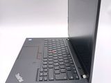 a laptop with a black keyboard on a white surface