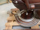 a brown leather chair sitting on top of a pallet