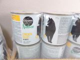 several cans of canned food are stacked on a shelf in a box