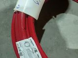 a roll of red electrical wire with a tag on it