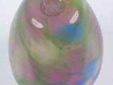 brightly colored glass object on white surface with white background