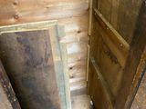 a wooden door in the corner of a room