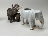 three figurines of elephants that are standing next to each other