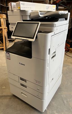 a printer sitting on top of a cart in a warehouse