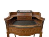 a wooden bench with a black leather seat on it