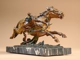 a statue of a man riding a horse on a marble base