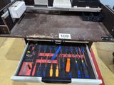 a drawer full of tools that is sitting on the floor