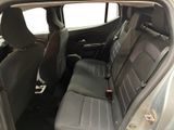 the back seats of a silver car with a black seat belt