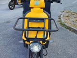 a yellow scooter parked on the side of the road