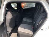 the back seats of a car with the door open in a parking lot