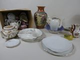 many different types of dishes and cups on the table