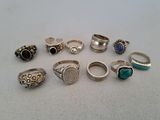 several different types of rings are arranged on a white surface