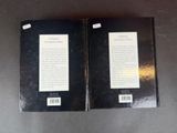 two black books sitting on top of a table next to each other