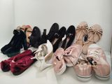 several pairs of women ' s shoes are lined up in a row