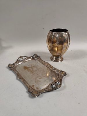 a silver tray and a silver vase on a table