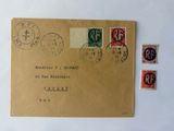 a brown envelope with stamps on it with a picture of a man