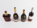 three bottles of liquor are lined up on a white surface