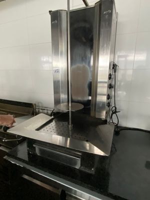 a man standing in a kitchen preparing food on the stove