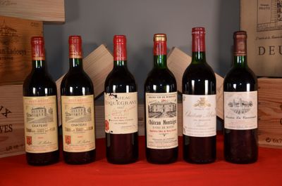 several bottles of wine are lined up on a red table