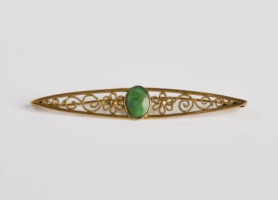 une barrette à cheveux « broche » dorée et verte