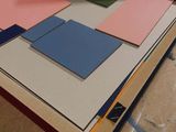 a pile of colored papers sitting on a table