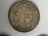 three old coins sitting on top of a table next to each other