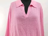 the top of a woman ' s shirt is pink and has a floral print skirt