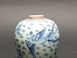 a blue and white vase with a bird design on it