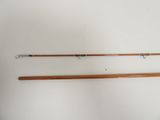 two wooden fishing rods on a white surface