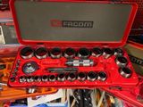 a red case with tools in it sitting on a table